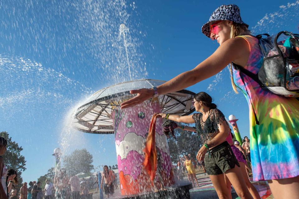 Festivalgoers refresh themselves from the heat during day 4 of the Bonnaroo Music and Arts Festival in Manchester, Tennessee, on June 19, 2022.