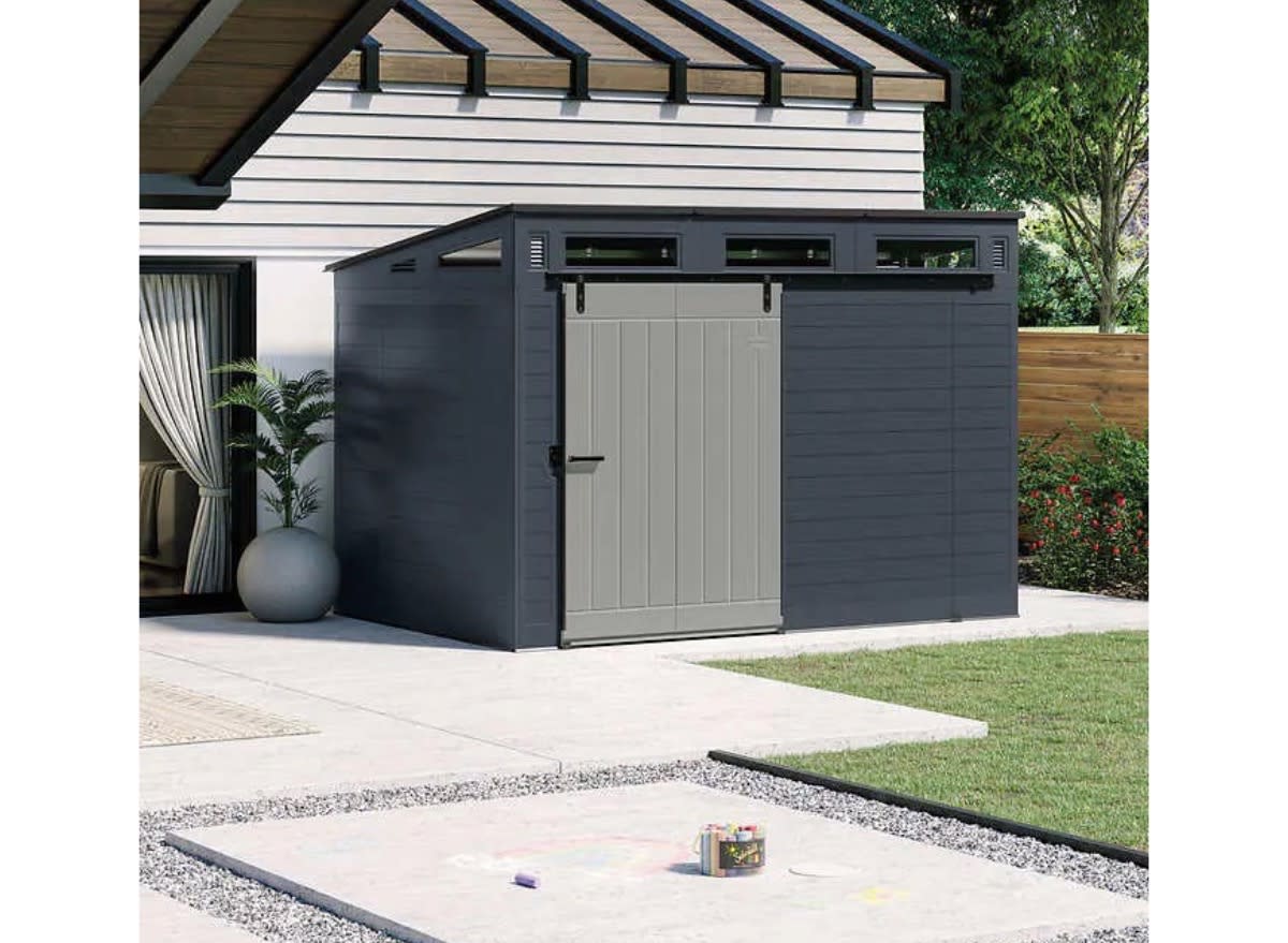 a suncast sliding door shed in a backyard.