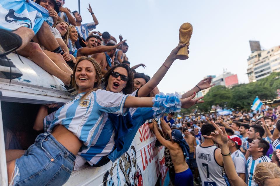 Fans of Argentina celebrate winning the Qatar 2022 World Cup against France at the Obelisk  in Buenos Aires, on December 18, 2022. (Photo by TOMAS CUESTA / AFP) (Photo by TOMAS CUESTA/AFP via Getty Images)