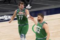 Dallas Mavericks' Luka Doncic (77) and Maxi Kleber (42) celebrate a 3-point basket scored by Doncic during the first half of an NBA basketball game against the New Orleans Pelicans in Dallas, Wednesday, May 12, 2021. (AP Photo/Tony Gutierrez)