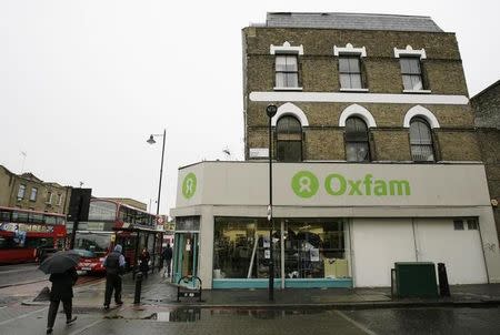 People walk past an Oxfam store in Dalston in east London November 28, 2008. REUTERS/Simon Newman/Files