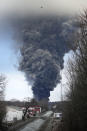 A black plume rises over East Palestine, Ohio, as a result of a controlled detonation of a portion of the derailed Norfolk and Southern trains Monday, Feb. 6, 2023. (AP Photo/Gene J. Puskar)