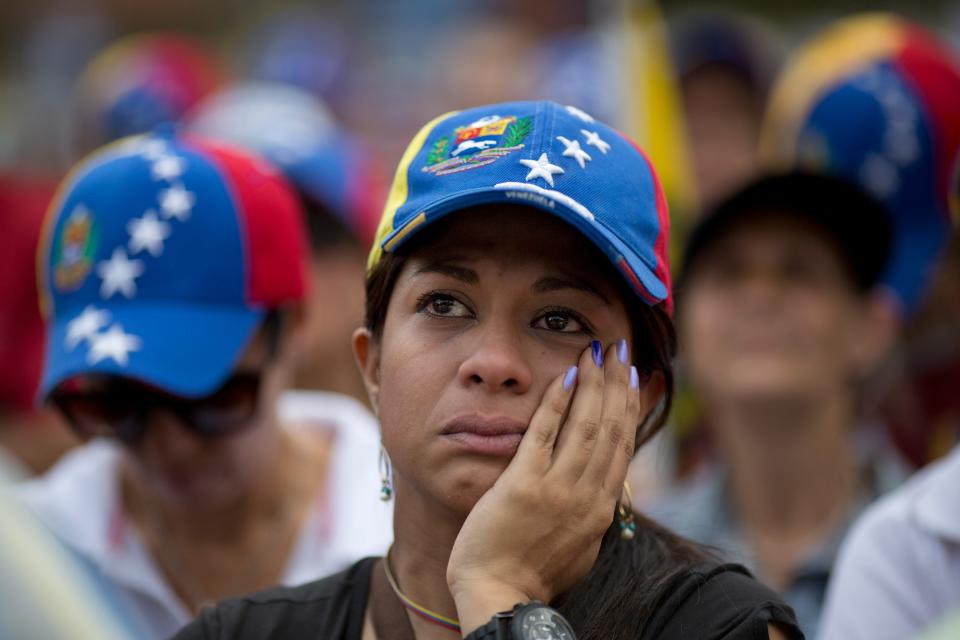A demonstrator attends a rally with human rights activists in Caracas, Venezuela, Friday, Feb. 28, 2014. The start of a weeklong string of holidays leading up to the March 5 anniversary of former President Hugo Chavez's death has not completely pulled demonstrators from the streets as the government apparently hoped. President Nicolas Maduro announced this week that he was adding Thursday and Friday to the already scheduled long Carnival weekend that includes Monday and Tuesday off, and many people interpreted it as an attempt to calm tensions. (AP Photo/Rodrigo Abd)