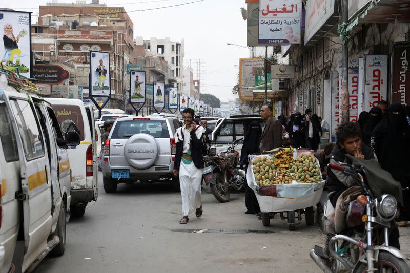 A man walks on a street in Sanaa