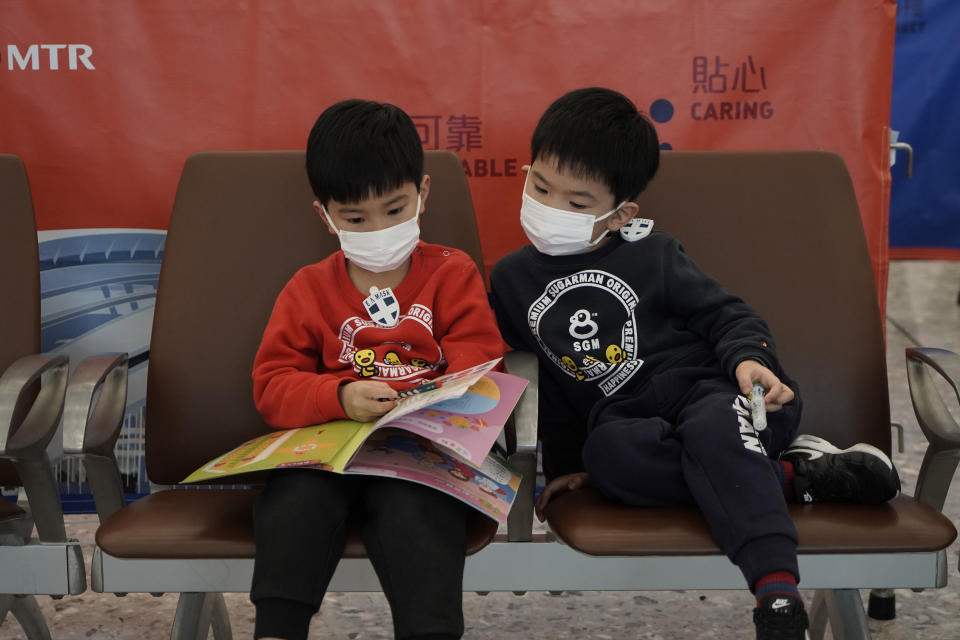 Passengers wear masks to prevent an outbreak of a new coronavirus in the high speed train station, in Hong Kong, Wednesday, Jan. 22, 2020. The first case of coronavirus in Macao was confirmed on Wednesday, according to state broadcaster CCTV. The infected person, a 52-year-old woman, was a traveller from Wuhan. (AP Photo/Kin Cheung)