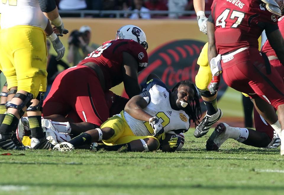 January 1,2013; Tampa, FL, USA; Michigan Wolverines running back Vincent Smith (2) reacts on the field after he was tackled by South Carolina Gamecocks defensive end Jadeveon Clowney (not pictured) and forced a fumble during the second half of the 2013 Outback Bowl at Raymond James Stadium. South Carolina Gamecocks defeated the Michigan Wolverines 33-28. Mandatory Credit: Kim Klement-USA TODAY Sports