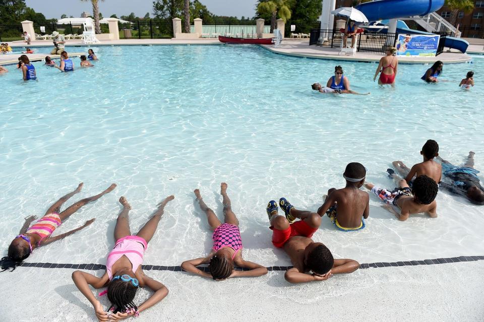 Children relax in the shallow end of the Courtyard Pool at Fort Eisenhower.