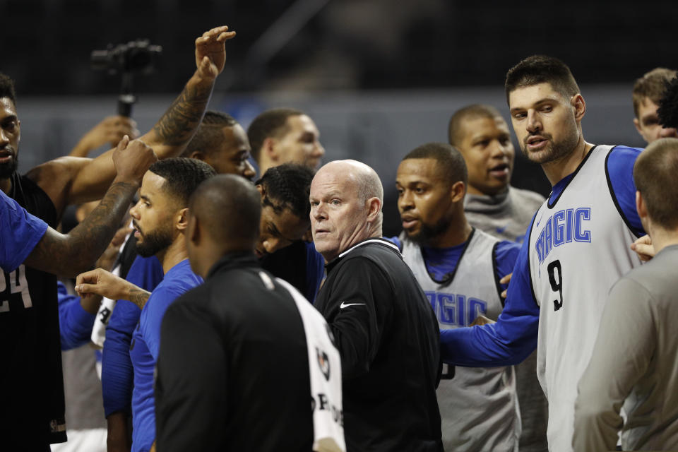 Orlando Magic coach Steve Clifford, center, stands with his players during a basketball practice at Mexico City Arena in Mexico City, Wednesday, Dec. 12, 2018. Magic will face the Chicago Bulls Thursday and the Utah Jazz Saturday in two 2018 regular-season NBA games to be played in the high-altitude Mexican capital. (AP Photo/Rebecca Blackwell)