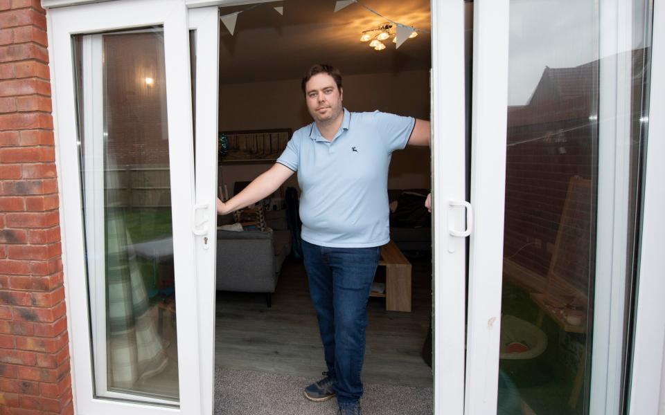 Ryan Kirkaldy demonstrates the faulty patio doors on his home - Dale Cherry