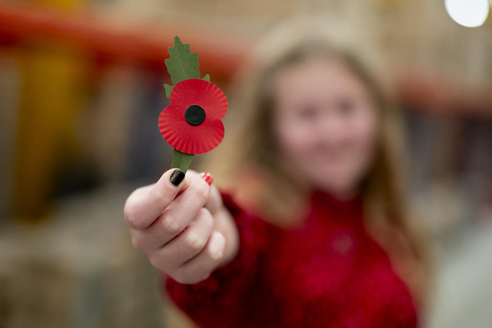 Maisie Mead, 12, a Poppy Appeal collector from Plymouth, holding the new plastic-free paper poppy, the first redesign of the poppy for 28 years, at the Royal British Legion's Poppy Appeal Warehouse in Aylesford, for the launch of the Royal British Legion Poppy Appeal 2023. Picture date: Thursday October 26, 2023. (Photo by Jordan Pettitt/PA Images via Getty Images)