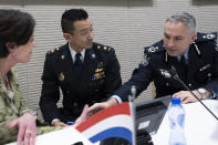 Assistant Commissioner David McLean of Australia, right, shakes hands with Prosecutor Digna van Boetzelaer, left, and Andy Kraag, Head of the National Criminal Investigations Division of the Netherlands, center, after a news conference of the Joint Investigation Team, JIT, in The Hague, Netherlands, Wednesday, Feb. 8, 2023, on the results of the ongoing investigation into other parties involved in the downing of flight MH17 on 17 July 2014. The JIT investigated the crew of the Buk-TELAR, a Russian made rocket launcher, and those responsible for supplying this Russian weapon system that downed MH17. (AP Photo/Peter Dejong)