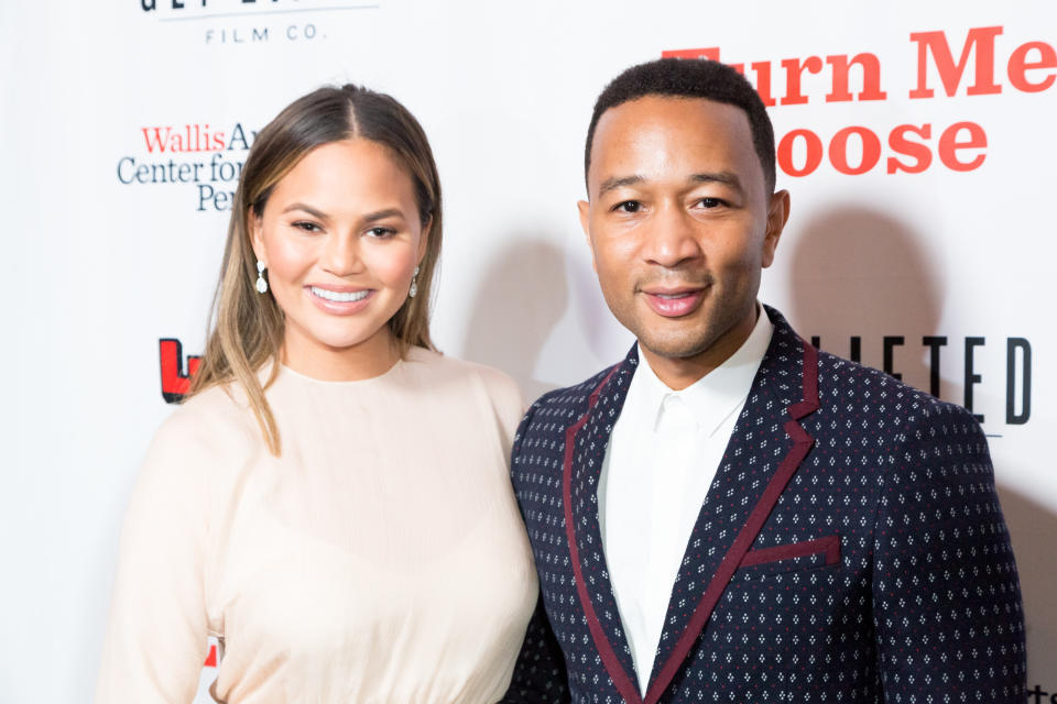 Chrissy Teigen, pictured with husband John Legend on Oct. 19, left one ginormous gratuity. (Photo: Greg Doherty via Getty Images)