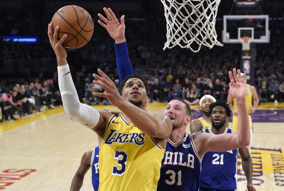 FILE - In this Jan. 29, 2019, file photo, Los Angeles Lakers guard Josh Hart, left, shoots as Philadelphia 76ers forward Mike Muscala defends during the second half of an NBA basketball game in Los Angeles. Two people familiar with the situation say the New Orleans Pelicans have agreed to trade six-time All-Star Anthony Davis to the Lakers for point guard Lonzo Ball, forward Brandon Ingram, Hart and three first-round draft choices. The people spoke to The Associated Press on condition of anonymity because the trade cannot become official until the new league year begins July 6. ESPN first reported the trade. (AP Photo/Mark J. Terrill, File)