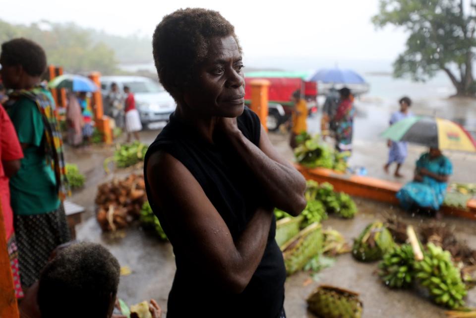 People gather at a local market during the first significant local rainfall in months in an extended dry season on December 6, 2019 in Tanna, Vanuatu.