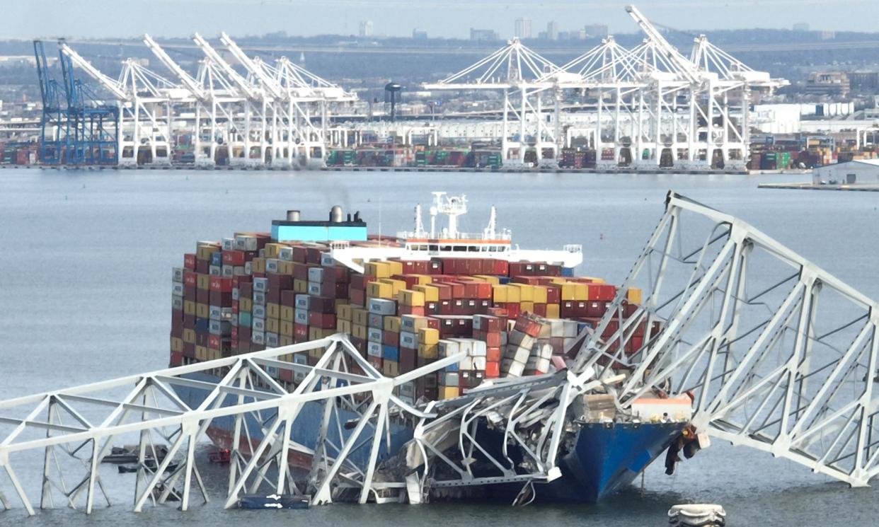 <span>The steel frame of the Francis Scott Key Bridge sits on top of a container ship in Baltimore, Maryland, on 26 March 2024. </span><span>Photograph: Jim Watson/AFP/Getty Images</span>