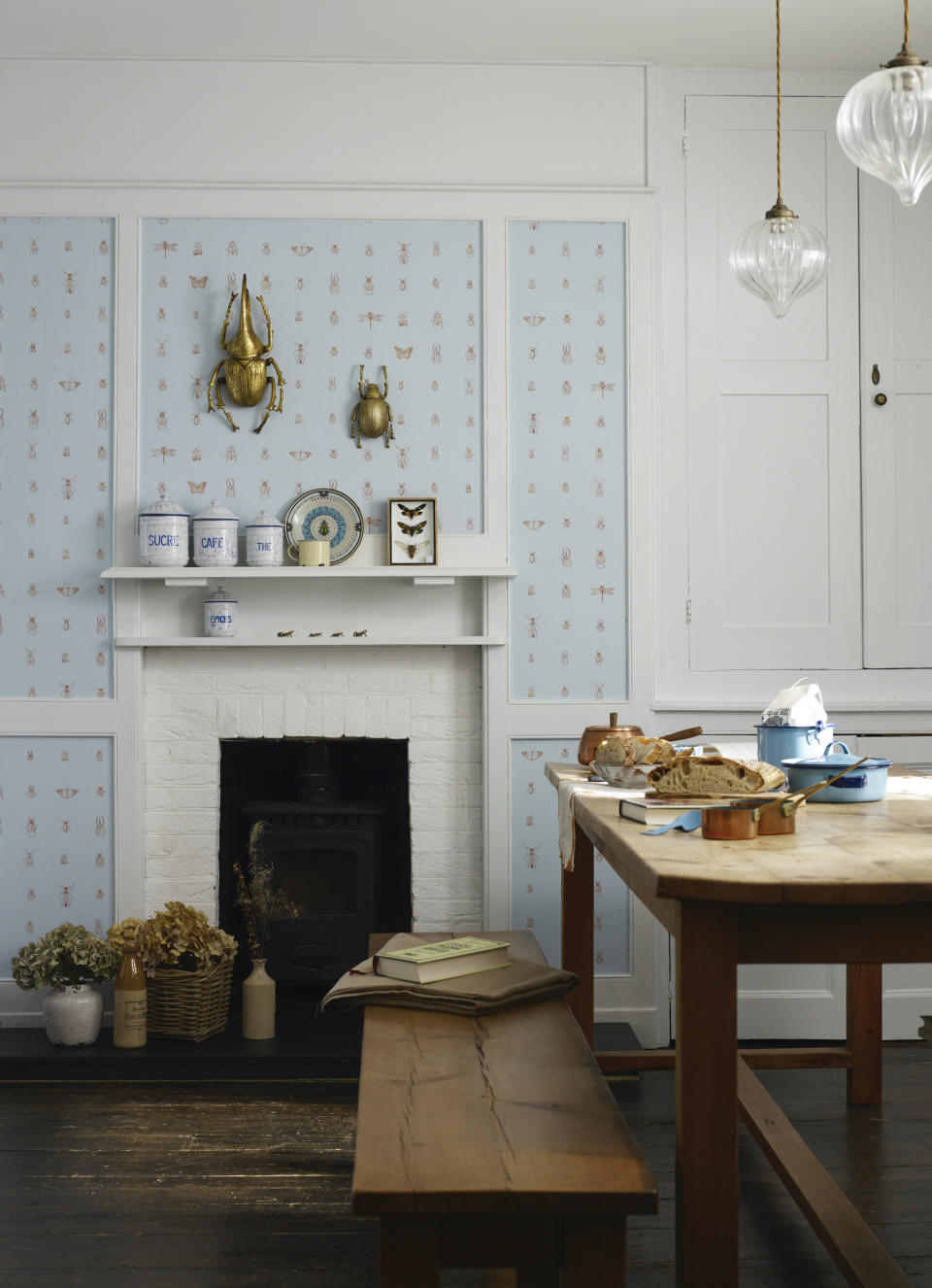 <p> Some may look at a paneled room and assume that wallpaper will not work, but this sweet space proves that is not the case. A well-chosen country kitchen wallpaper with a simple repeat pattern can add additional character to a room with plenty of period features.&#xA0; </p> <p> When choosing a country kitchen wallpaper, designer Elizabeth Ockford suggests that you bear in mind that the kitchen is the space &#x2018;where the outside and inside of the house meet &#x2013; be that fruit and vegetables or flowers coming in from the garden, or where the family and pets gather to cozy up after a country walk or over a long lunch. And wallpaper in that room can reflect that, in color and subject matter.&apos; </p> <p> In Ockford&apos;s Cleo wallpaper, you get a large variety of common or garden bugs, delicately drawn onto clean-colored grounds. </p>