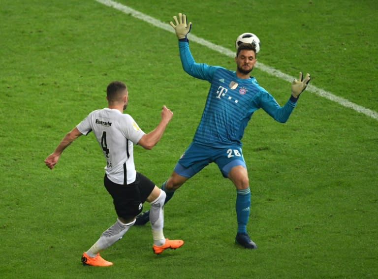 Frankfurt's Croatian forward Ante Rebic (L) scores past Bayern Munich's German goalkeeper Sven Ulreich during the German Cup DFB Pokal final football match FC Bayern Munich vs Eintracht Frankfurt at the Olympic Stadium in Berlin on May 19, 2018