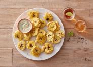 <p>Though they’re typically twice fried, these tostones are as crispy as the classic version with a fraction of the fat thanks to an air fryer. The mojo-inspired sauce is so good and easy to make, you’ll want to eat it with a spoon.</p><p>Get the <strong><a href="https://www.delish.com/cooking/recipe-ideas/a39720995/air-fryer-tostones-recipe/" rel="nofollow noopener" target="_blank" data-ylk="slk:Air Fryer Tostones With Creamy Mojo Dipping Sauce recipe;elm:context_link;itc:0;sec:content-canvas" class="link ">Air Fryer Tostones With Creamy Mojo Dipping Sauce recipe</a></strong>.</p>