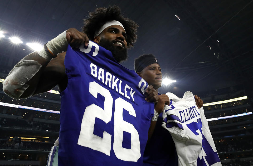 Ezekiel Elliott and Saquon Barkley trade jerseys after a game last season. (Getty Images)