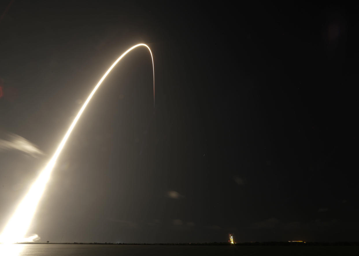 A Falcon 9 SpaceX rocket, with a payload of 60 satellites for SpaceX's Starlink broadband network, lifts off from Space Launch Complex 40 during a time exposure at the Cape Canaveral Air Force Station in Cape Canaveral, Fla., Thursday, May 23, 2019. (AP Photo/John Raoux)