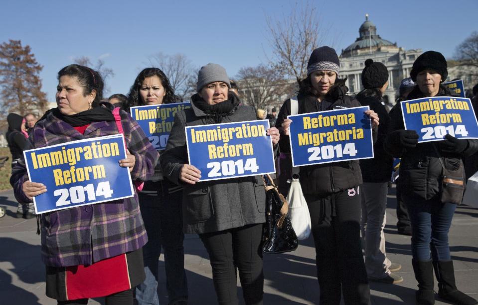 FILE - This Dec. 12, 2013 file photo shows immigration activists gathered on Capitol Hill in Washington. A chief Republican foe of immigration legislation says it would be a “colossal mistake” for the House to consider any measure this year and shift attention from President Barack Obama’s health care law. The comments by Rep. Steve King of Iowa on Wednesday underscore the difficulty for advocates who have raised expectations for congressional action on the contentious issue. (AP Photo/J. Scott Applewhite, File)