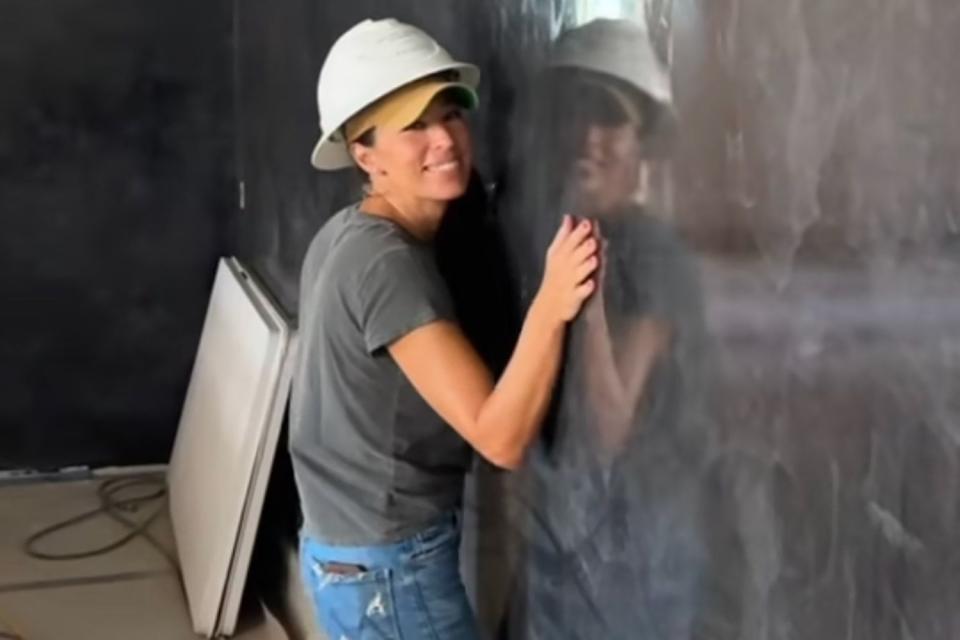 <p>joannagaines/Instagram</p> Joanna Gaines hugs the high gloss Venetian plaster walls in Hotel 1928.