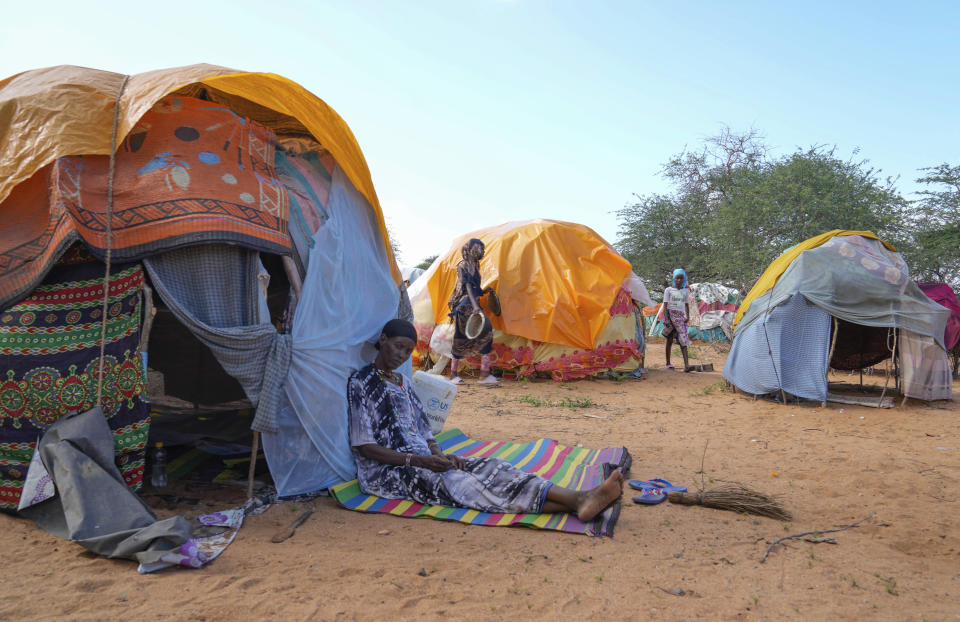 A Internally displaced woman sits outside her makeshift shelter at a displaced camp after El Nino rains damaged her house in Bangale town, Tana River county, in Kenya, Sunday, Nov. 26, 2023. Severe flooding in the country has killed at least 71 people and displaced thousands, according to estimates from the UN Office for the Coordination of Humanitarian Affairs. (AP Photo/Brian Inganga)