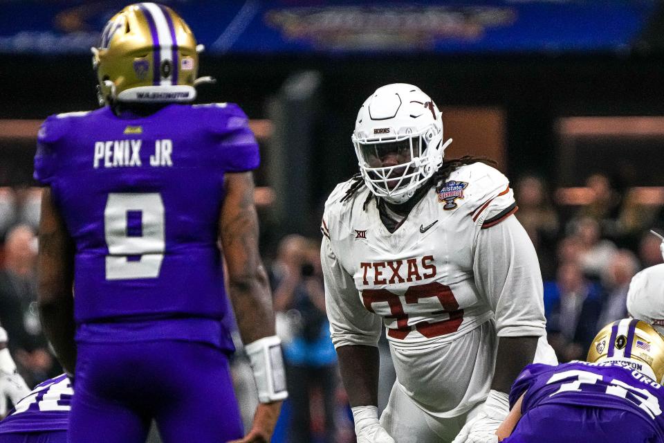 Texas Longhorns defensive lineman T’Vondre Sweat (93) watches Washington quarterback <a class="link " href="https://sports.yahoo.com/ncaaf/players/286878/" data-i13n="sec:content-canvas;subsec:anchor_text;elm:context_link" data-ylk="slk:Michael Penix Jr;sec:content-canvas;subsec:anchor_text;elm:context_link;itc:0">Michael Penix Jr</a>. (9) before a snap during the Sugar Bowl College Football Playoff semifinals game at the Caesars Superdome on Monday, Jan. 1, 2024 in New Orleans, Louisiana.