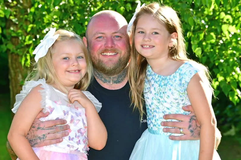 Philip with his daughters Kayla, six and Norah, seven