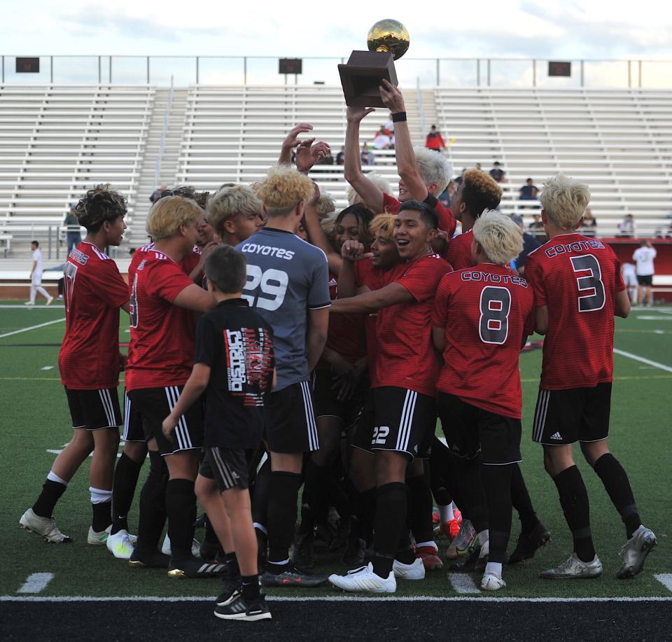 The Wichita Falls High School soccer team hoists their trophy in celebration against Arlington Heights on Tuesday, March 30, 2021, in Mineral Wells.