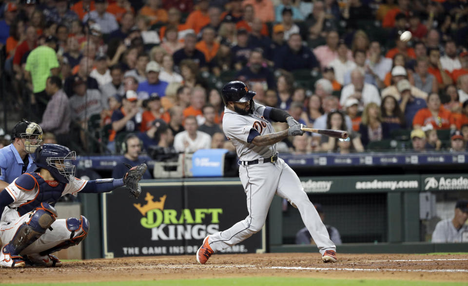 Detroit Tigers' Ronny Rodriguez (60) hits a home run as Houston Astros catcher Robinson Chirinos reaches for the pitch during the fifth inning of a baseball game Wednesday, Aug. 21, 2019, in Houston. (AP Photo/David J. Phillip)