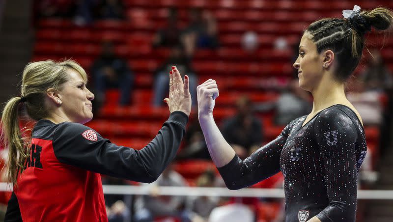 Utah gymnastics assistant coach Carly Dockendorf high-fives gymnast Emilie LeBlanc before she competes on the beam during the Red Rocks Preview gymnastics event at the Jon M. Huntsman Center on the University of Utah campus in Salt Lake City on Friday, Dec. 13, 2019.