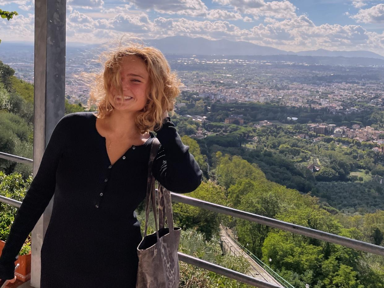 Stacia Datskovska in front of a city landscape