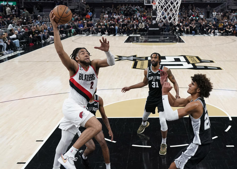 Portland Trail Blazers forward Trendon Watford (2) drives to the basket against San Antonio Spurs forward Dominick Barlow, right, during the first half of an NBA basketball game in Austin, Texas, Thursday, April 6, 2023. (AP Photo/Eric Gay)