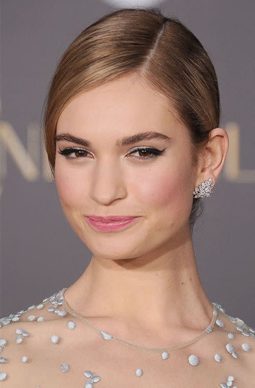 Lily James nailed the fairytale princess look with shimmery pink lips, rosy cheeks and silvery lids while on the promotional trail for her new film, <i>Cindarella</i>.