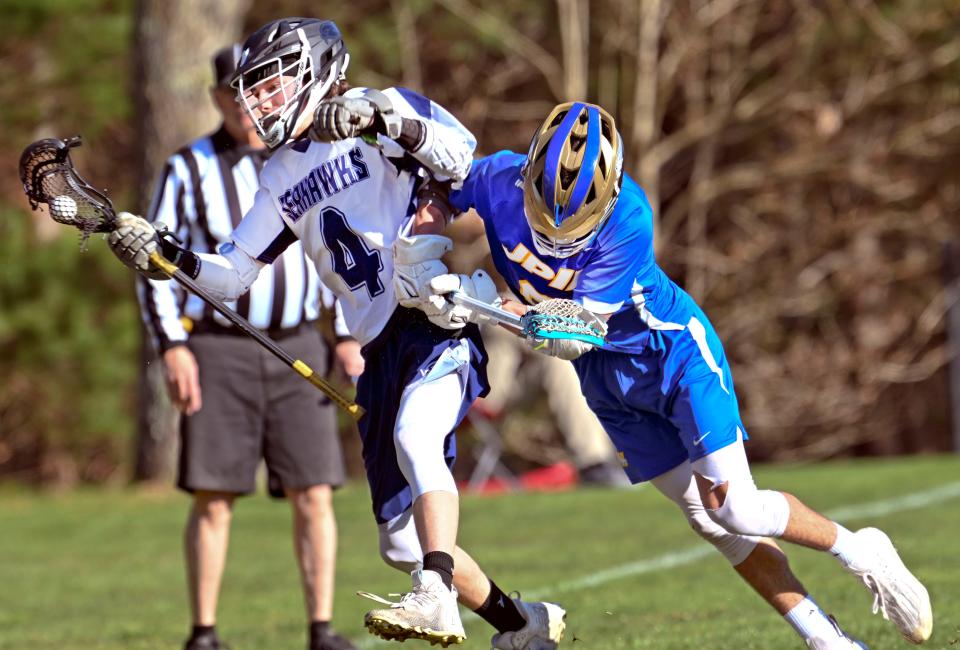 Jake Hyde of St. John Paul II pushes Jack Bunnell of Cape Cod Academy out of bounds.