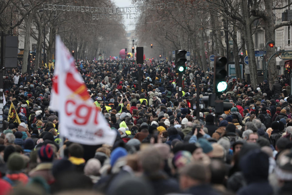 FILE - Protestors march during a demonstration against pension changes, Thursday, Jan. 19, 2023 in Paris. France's national rail operator is recommending that passengers work from home if possible Tuesday Jan. 31, 2023 to spare them from labor strikes over pensions that are expected to cause major transport woes. (AP Photo/Lewis Joly, FILE)