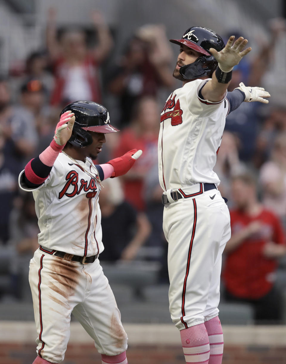 Atlanta Braves' Dansby Swanson, right, celebrates with Ozzie Albies after hitting a home run off Philadelphia Phillies' Aaron Nola during the first inning of a baseball game Sunday, May 9, 2021, in Atlanta. (AP Photo/Ben Margot)