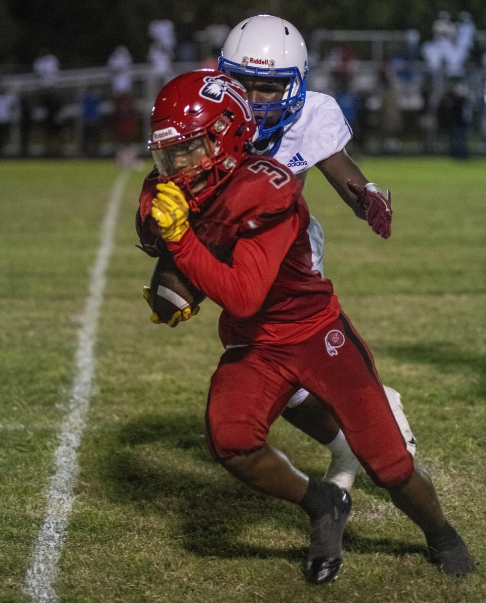 Santaluces #3 Elijah Rodriguez runs for yards before being tackled by Pahokee # 10 Zion Booth during the game held at Santaluces High School.