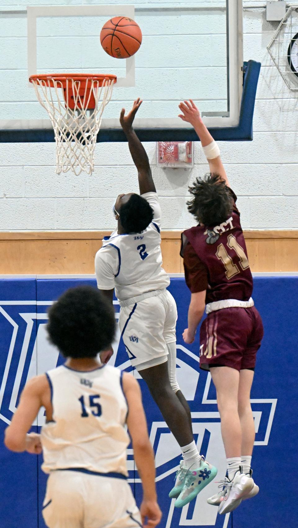 In this game from February 2022, Keno Glenn of Upper Cape Tech puts up a breakaway layup followed closely by Trevor Ryone of Cape Tech.