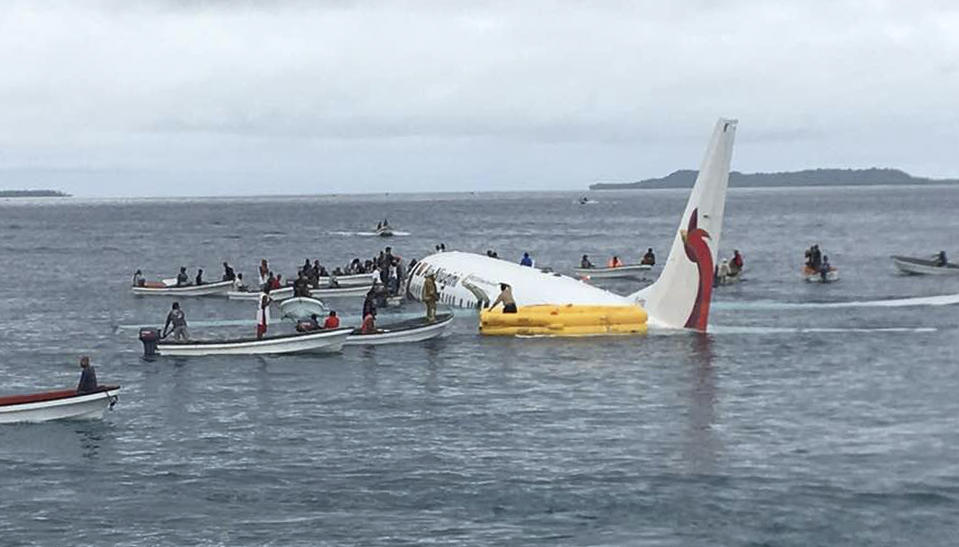 Local fishing boats move in to recover the passengers and crew of Air Niugini flight. Source: AP