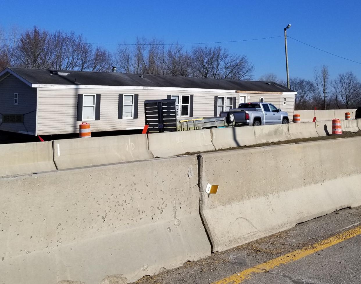 Photos show a mobile home stuck on an Ohio highway after the driver hauling the home had to leave it when its width wouldn't make it through a detour.