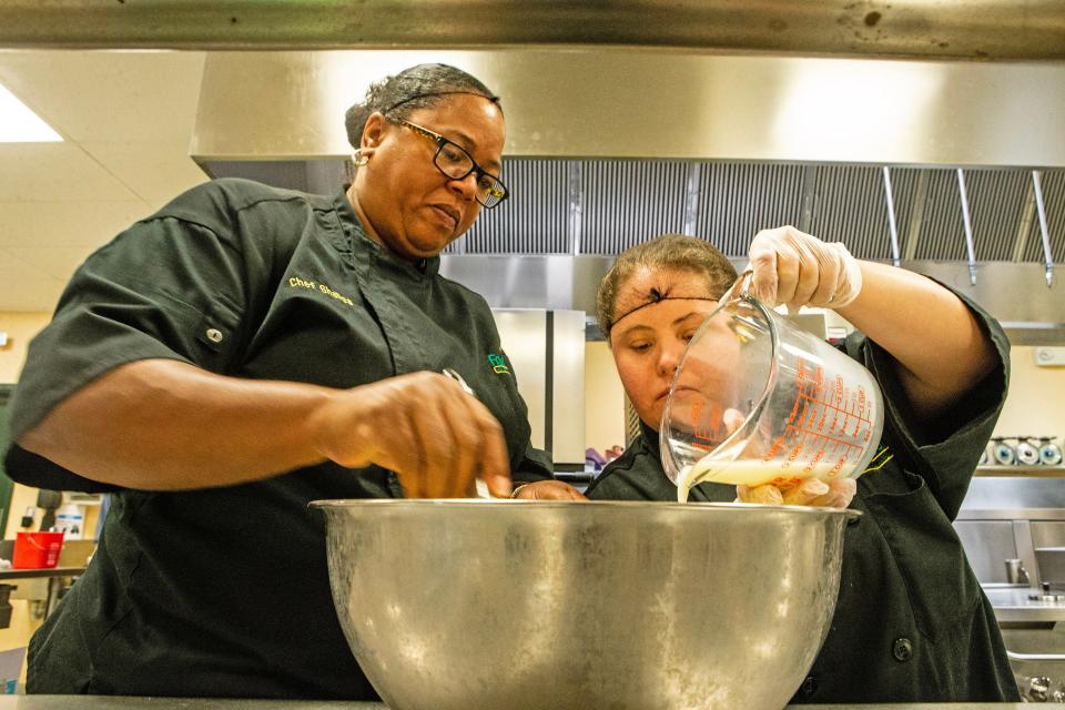 Chef Instructor Shalisa Alexander and student Kayla Strohmeyer prepare batter during cooking classes at the Kitchen School at the Food Bank of Delaware in Milford on Tuesday, July 11, 2023. The Milford branch offers specialized training in the food and hospitality industries for adults with disabilities, with the first-ever class out of the branch graduating on Thursday, July 13, 2023.