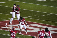 Indiana's Joseph Daniels Jr. (20), Cam Jones (4) and Noah Pierre (21) celebrate after Indiana defeated Penn State in overtime of an NCAA college football game, Saturday, Oct. 24, 2020, in Bloomington, Ind. (AP Photo/Darron Cummings)