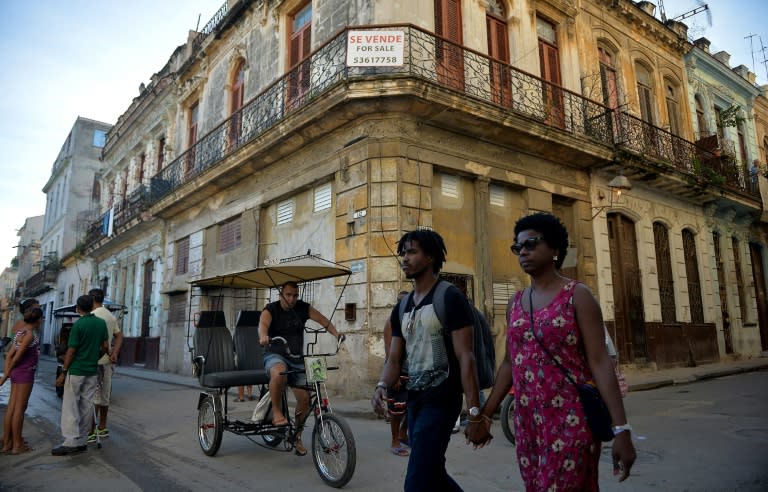 People walk past a building for sale in Havana, Cuba, as US Secretary of State Mike Pompeo warned foreign businesses to steer clear of formerly private properties seized by the island nation