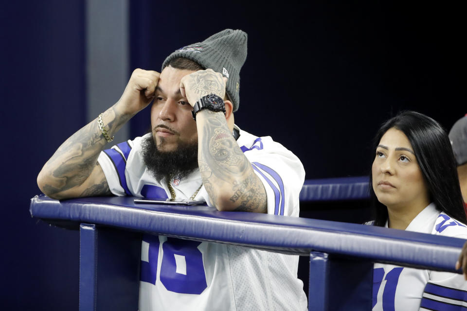 Dallas Cowboys fans react during the second half of an NFL wild-card playoff football game between the Cowboys and the San Francisco 49ers in Arlington, Texas, Sunday, Jan. 16, 2022. (AP Photo/Roger Steinman)