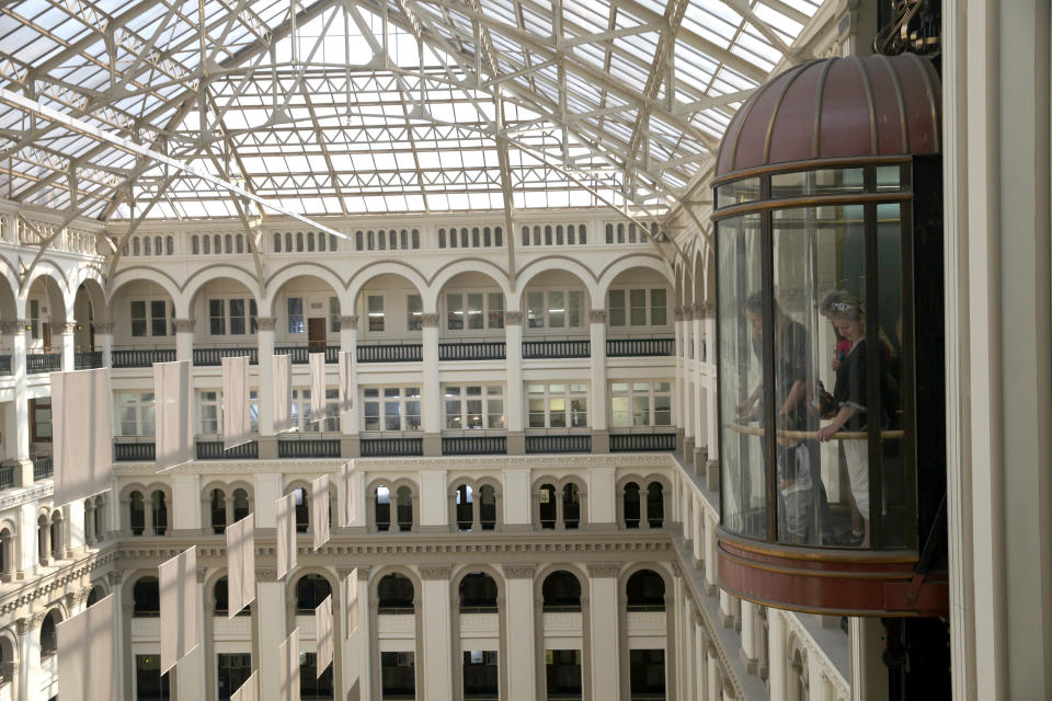 Visitors ride in an elevator at the Old Post Office Pavilion in Washington, D.C., on Thursday, June 20, 2013. (Photo: Bloomberg via Getty Images)