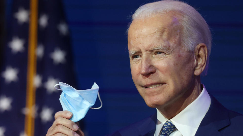 President-elect Joe Biden holds a face mask as he speaks to reporters about efforts to confront the coronavirus pandemic after meeting with members of his "Transition COVID-19 Advisory Board" in Wilmington, Delaware, on Monday. (Jonathan Ernst/Reuters)