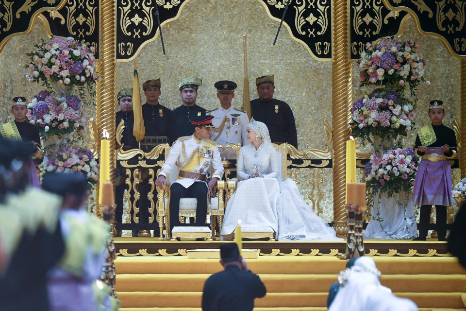 In this photo released by Brunei's Information Department, Brunei's Prince Abdul Mateen, center left, and bride Anisha Rosnah attend their wedding reception at Istana Nurul Iman in Bandar Seri Begawan, Brunei Sunday, Jan. 14, 2024. (Brunei's Information Department via AP)