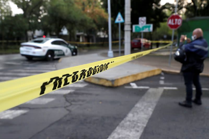 A police cordon tape is seen at an area where a shooting took place in Mexico City